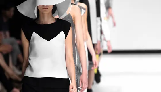 Models walk down a runway during a fashion show.