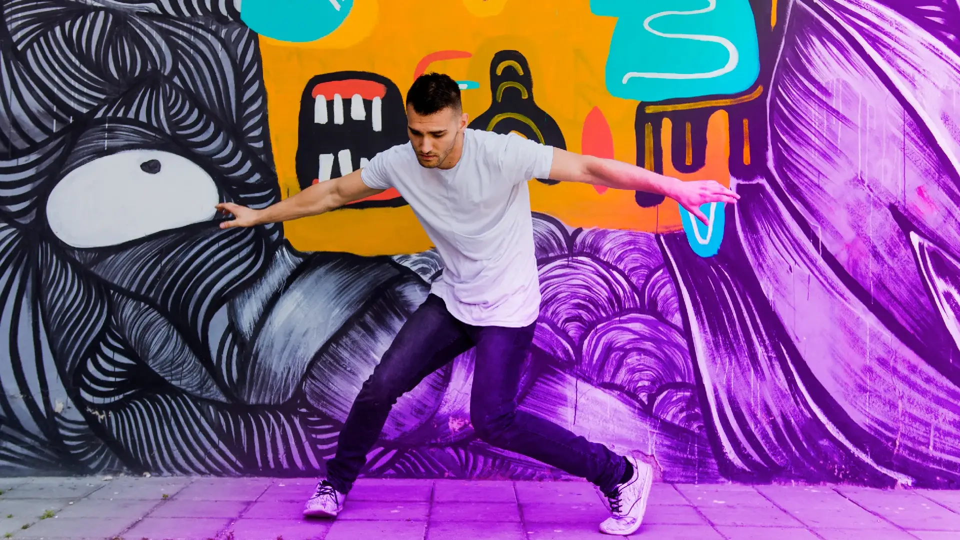 Man Dancing In Front Of Graffiti Art